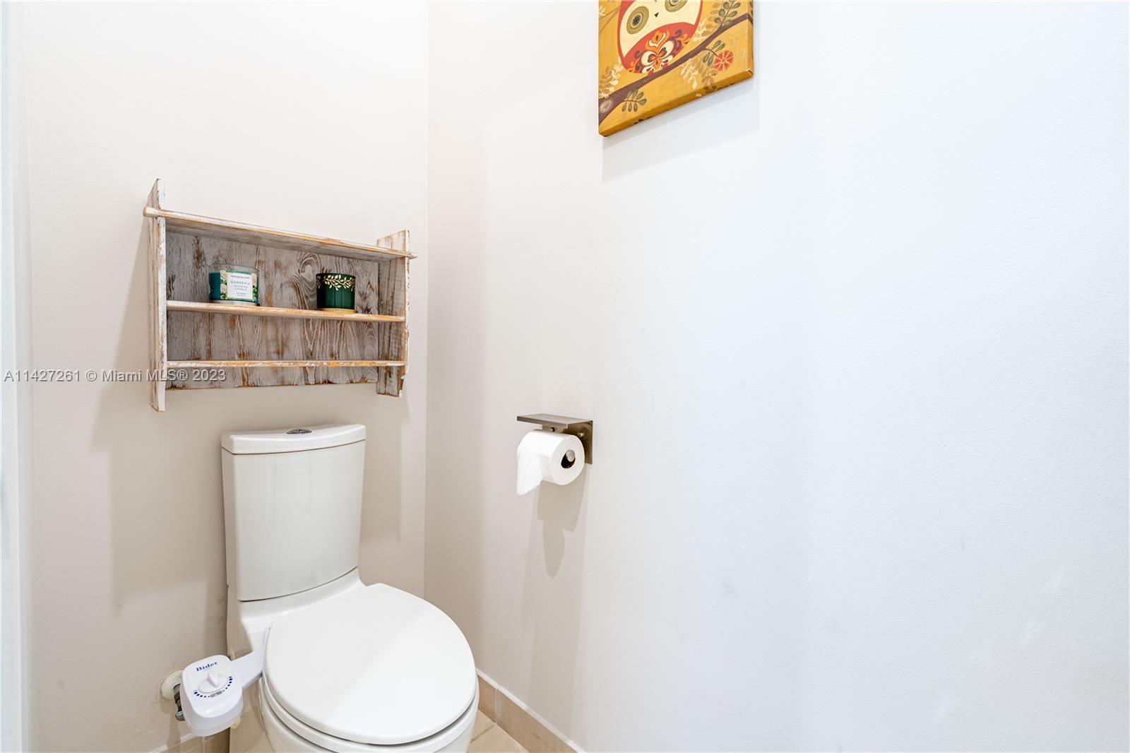 8210 Northwest 46th Street Doral, FL 33166 - Photo 33 of 59 a white toilet sitting next to a bathroom sink