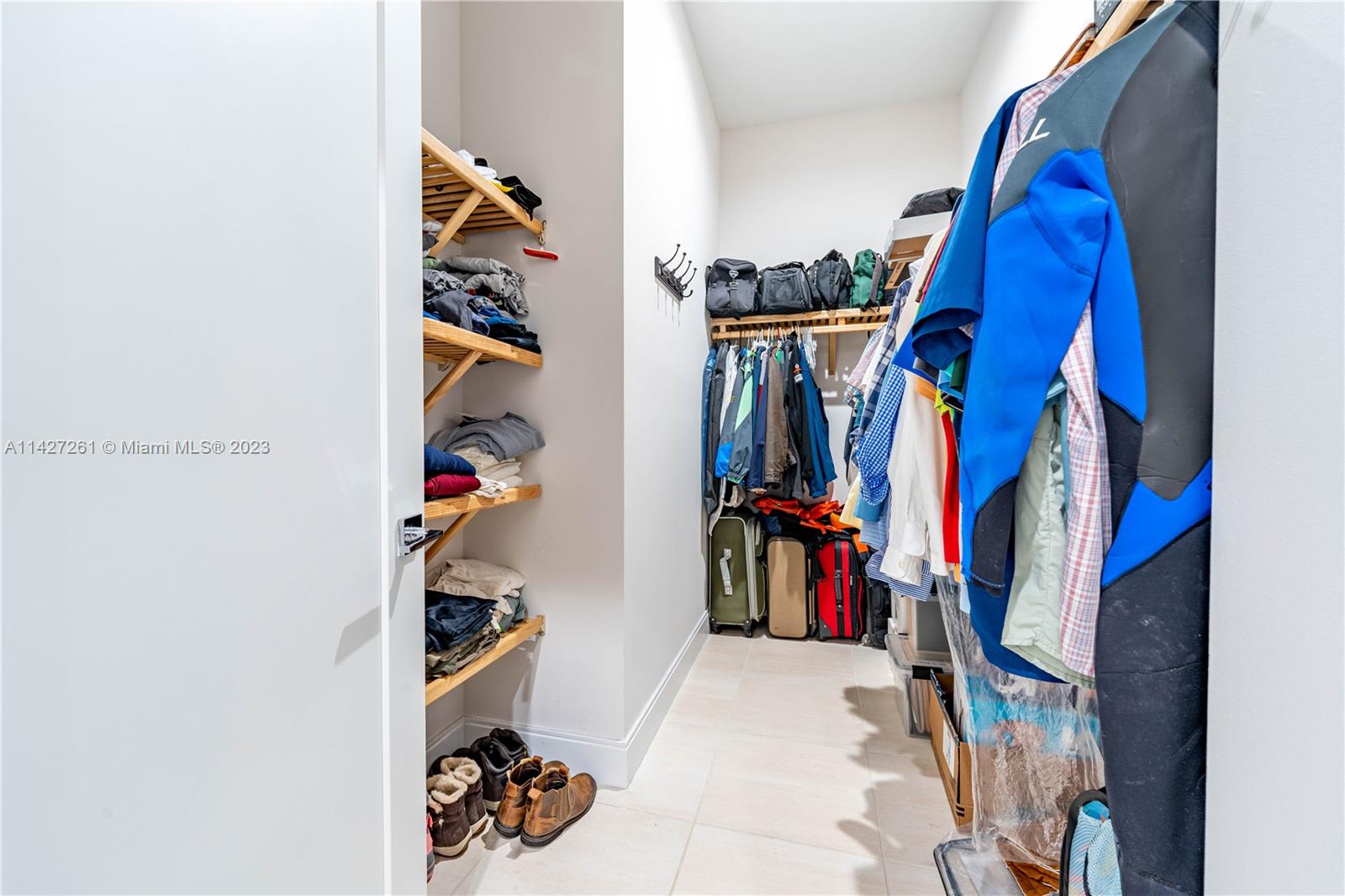 8210 Northwest 46th Street Doral, FL 33166 - Photo 34 of 59 a view of walk in closet with clothes and shoes