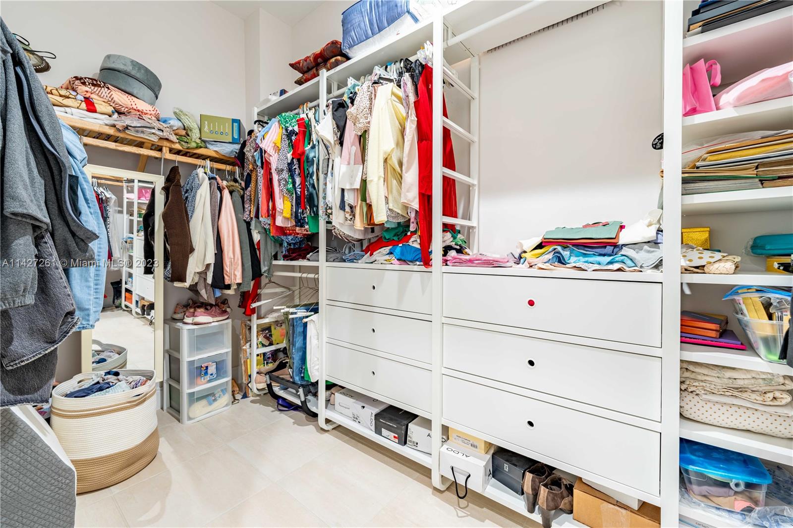 8210 Northwest 46th Street Doral, FL 33166 - Photo 35 of 59 a view of walk in closet with clothes and shoes