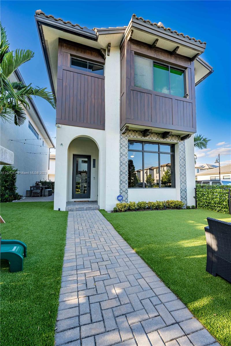 8210 Northwest 46th Street Doral, FL 33166 - Photo 49 of 59 a front view of a house with garden