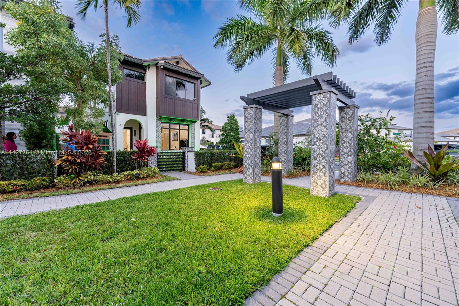 8210 Northwest 46th Street Doral, FL 33166 - Photo 54 of 59 a front view of a house with garden