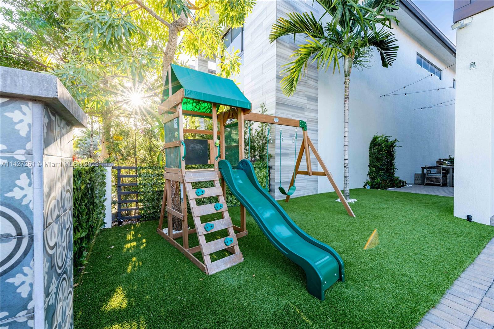 8210 Northwest 46th Street Doral, FL 33166 - Photo 6 of 59 a view of backyard with a slide and potted plants