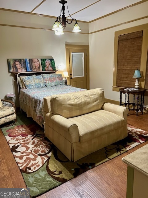 3 South Spring Street Claxton, GA 30417 - Photo 13 of 17 a bedroom with bed and a chandelier