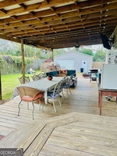 3 South Spring Street Claxton, GA 30417 - Photo 17 of 17 a view of a patio with table and chairs under an umbrella with a barbeque grill and couches