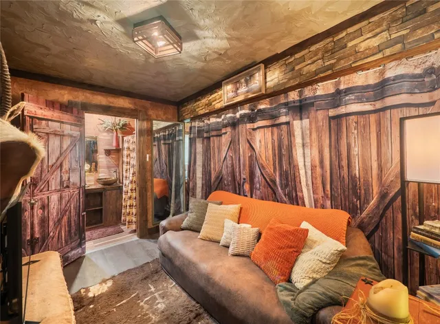 a living room with furniture a ceiling fan and a rug