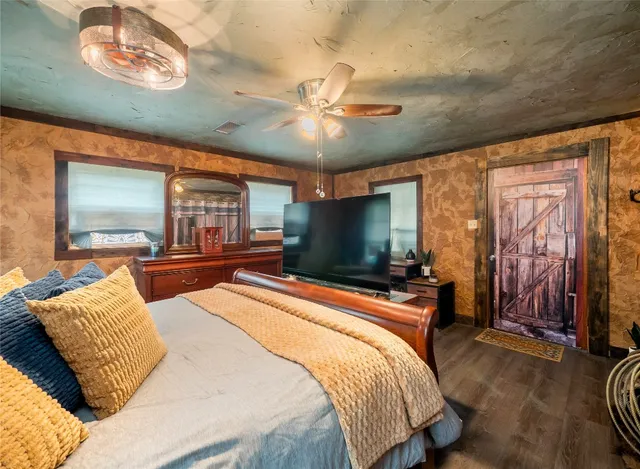 a bedroom with a bed and a flat screen tv