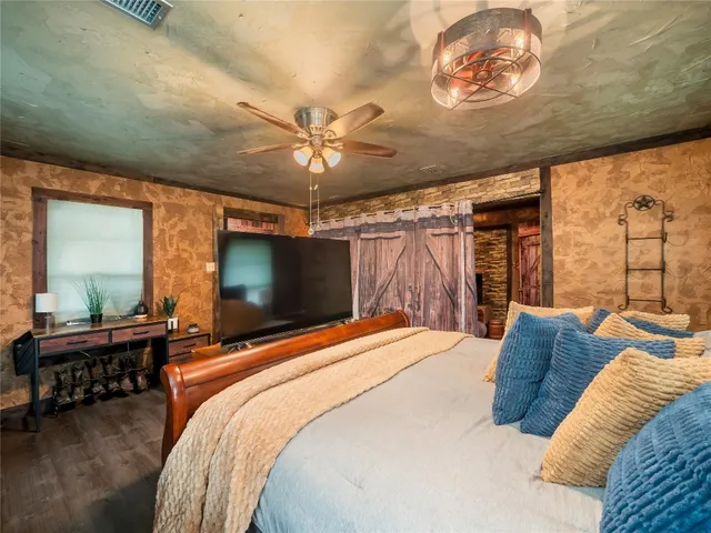 a bedroom with a bed and a chandelier