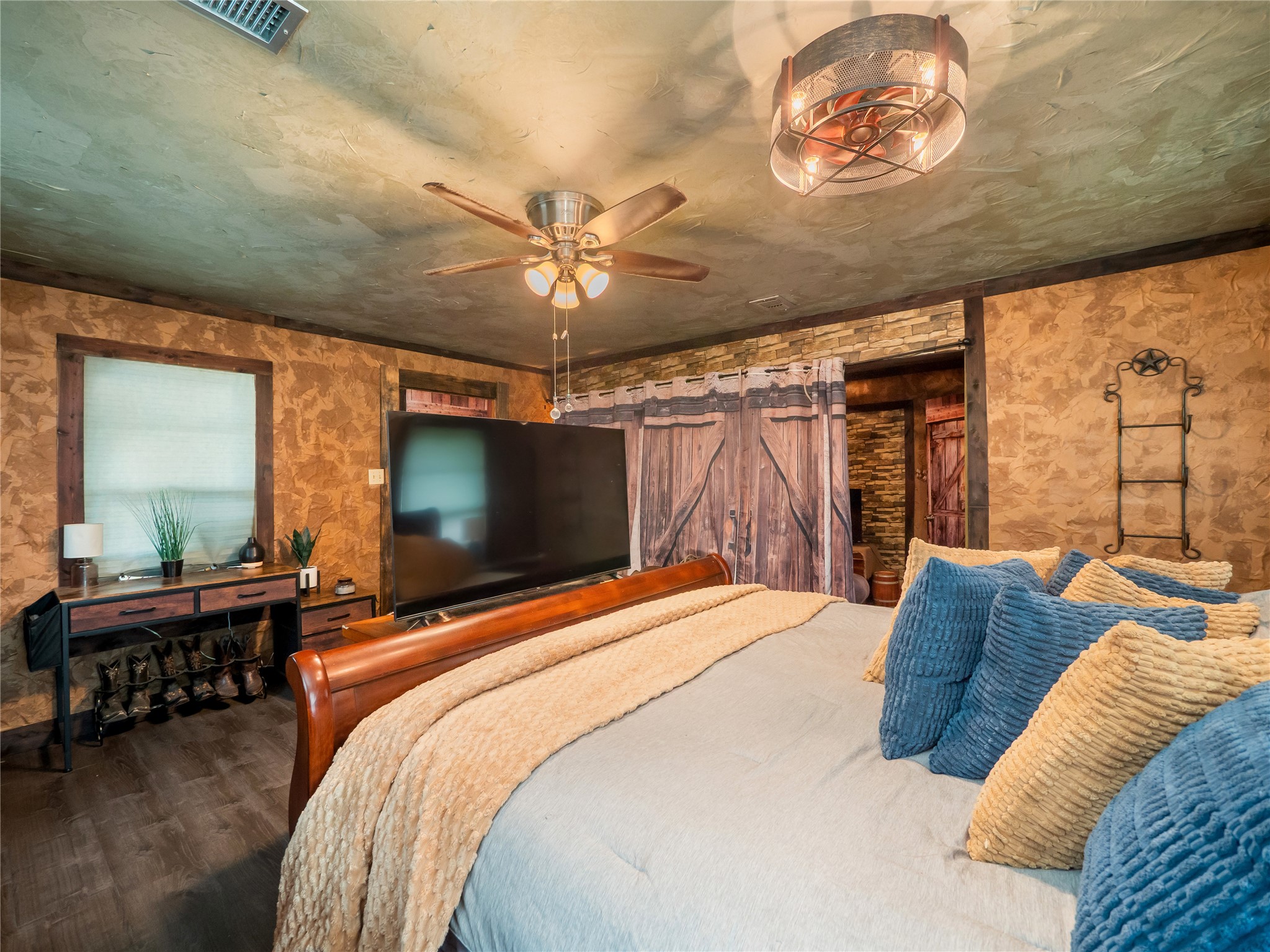 1207 Flag Street Llano, TX 78643 - Photo 15 of 40 a bedroom with a bed and a chandelier