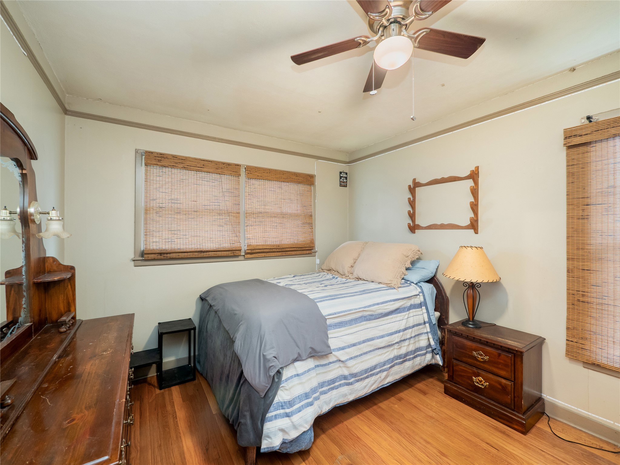1207 Flag Street Llano, TX 78643 - Photo 19 of 40 a bedroom with a bed chandelier and a window