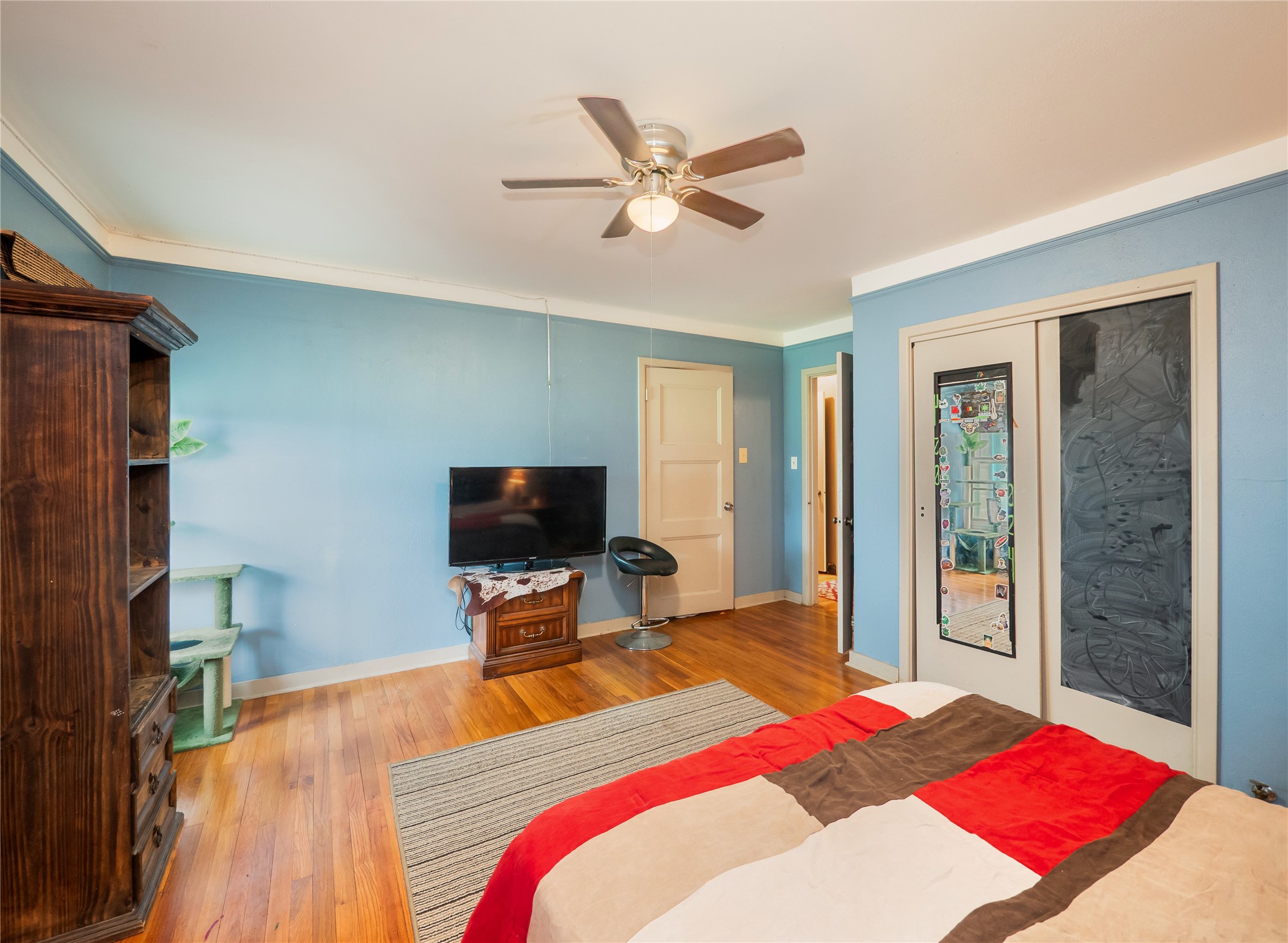 1207 Flag Street Llano, TX 78643 - Photo 23 of 40 a bedroom with a bed and a flat screen tv