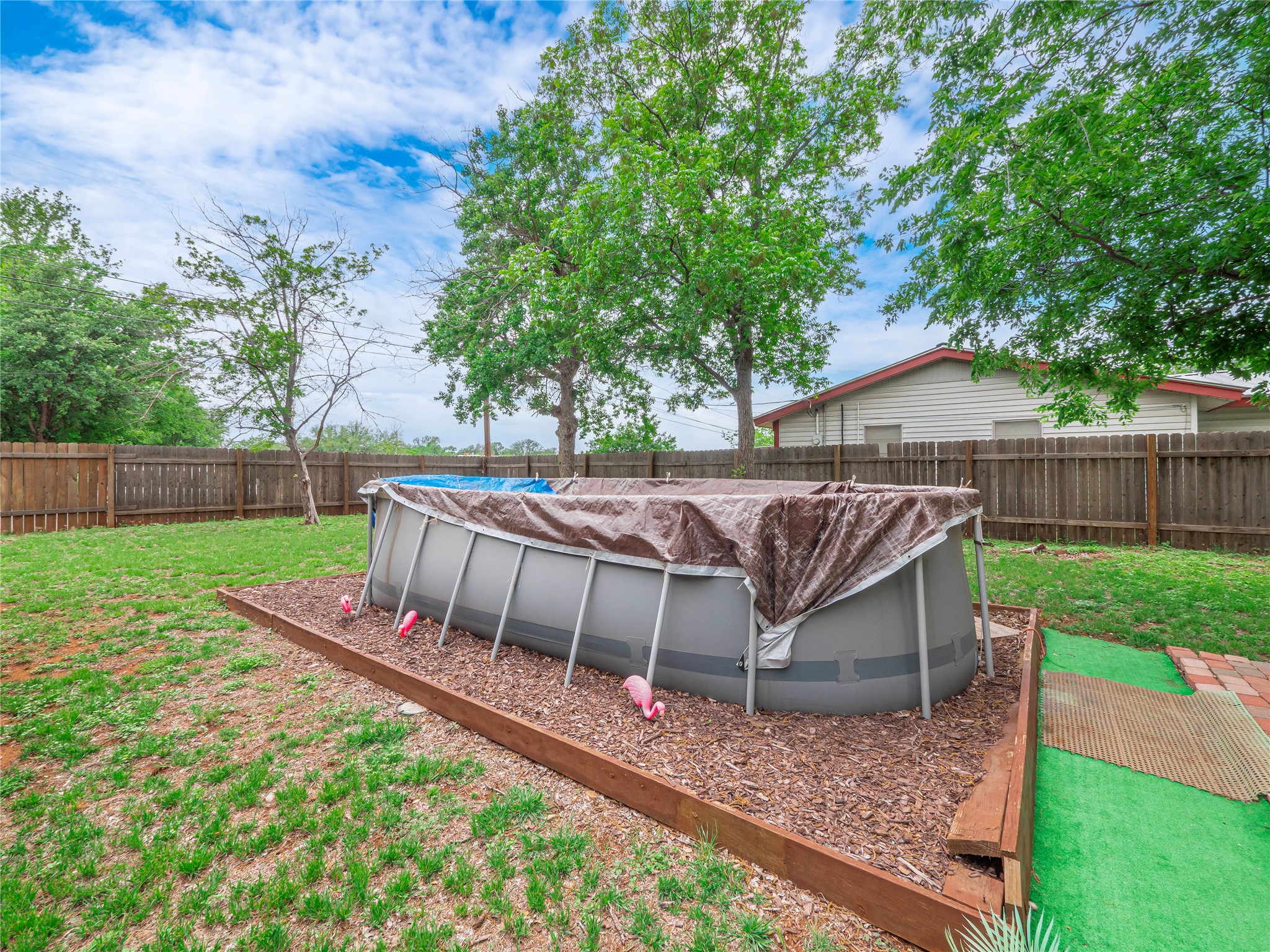 1207 Flag Street Llano, TX 78643 - Photo 34 of 40 a view of a yard with a deck furniture and a garden