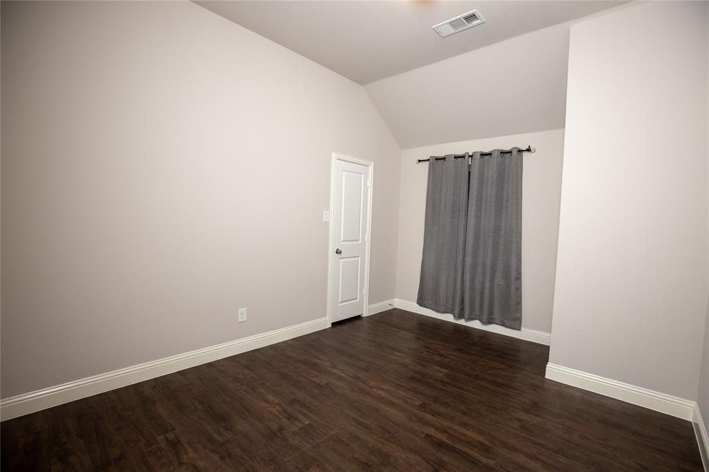 987 Canterbury Lane Forney, TX 75126 - Photo 11 of 22 a view of an empty room with wooden floor