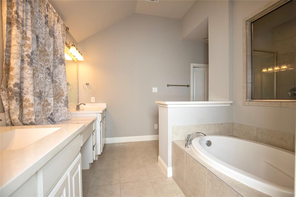 987 Canterbury Lane Forney, TX 75126 - Photo 13 of 22 a bathroom with a tub sink and mirror