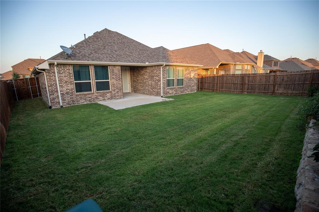 987 Canterbury Lane Forney, TX 75126 - Photo 20 of 22 a view of a house with a backyard