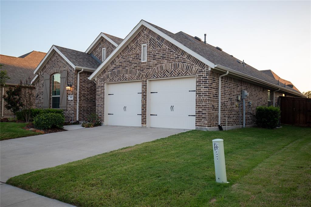 987 Canterbury Lane Forney, TX 75126 - Photo 2 of 22 a front view of a house with a yard