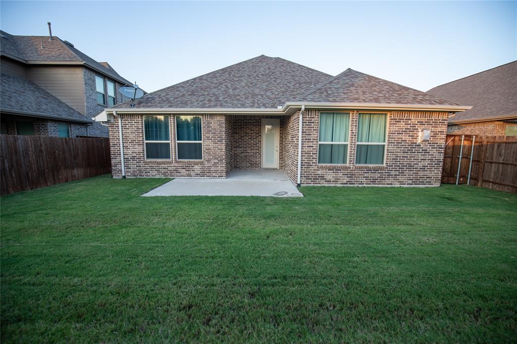 987 Canterbury Lane Forney, TX 75126 - Photo 22 of 22 a front view of a house with a yard and porch