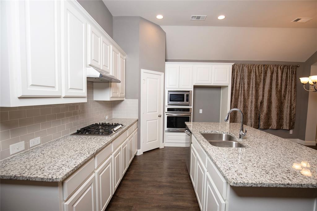 987 Canterbury Lane Forney, TX 75126 - Photo 4 of 22 a kitchen with stainless steel appliances granite countertop a sink stove and refrigerator