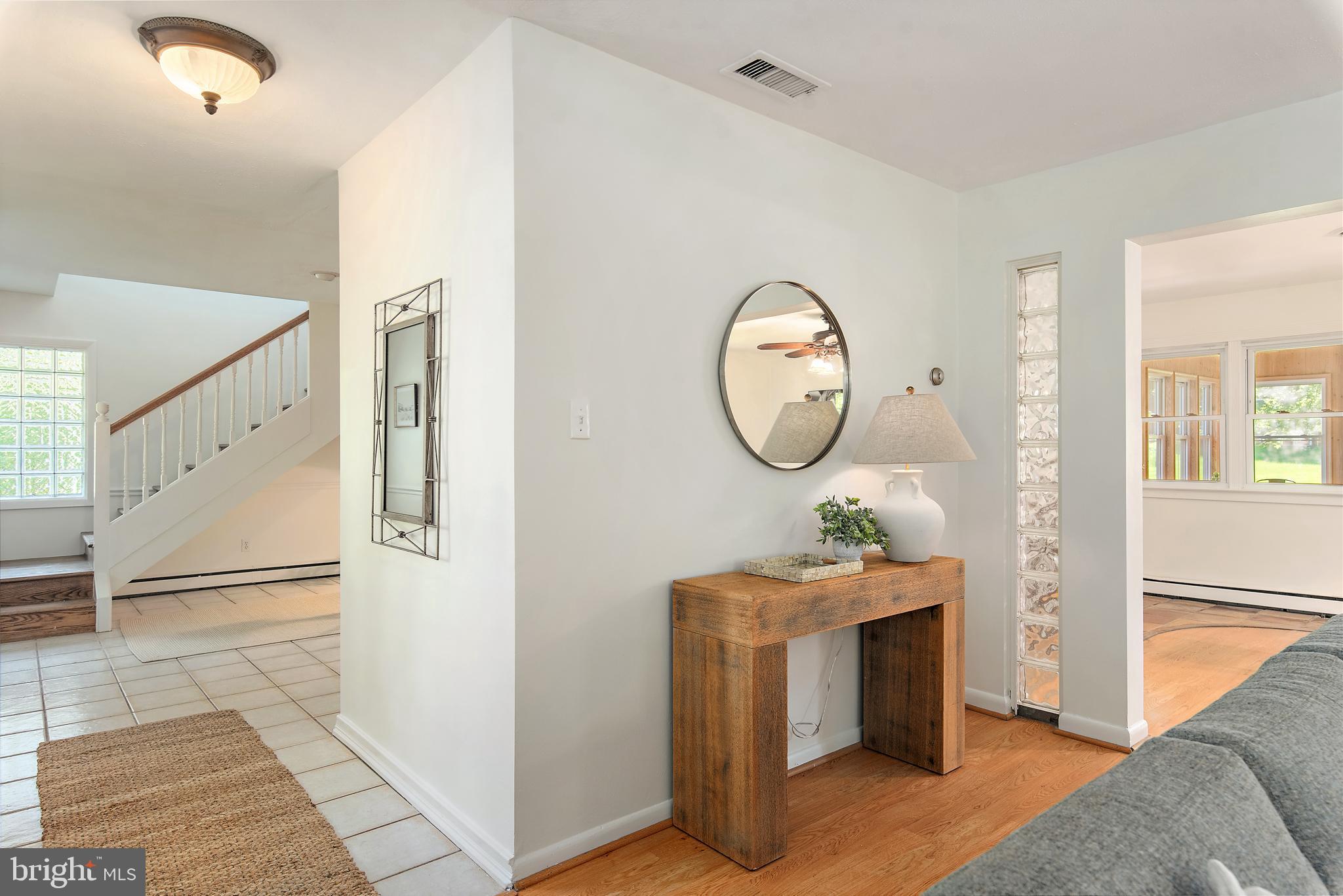 3514 Williamsburg Road Davidsonville, MD 21035 - Photo 17 of 50 a room with furniture a mirror and a fireplace