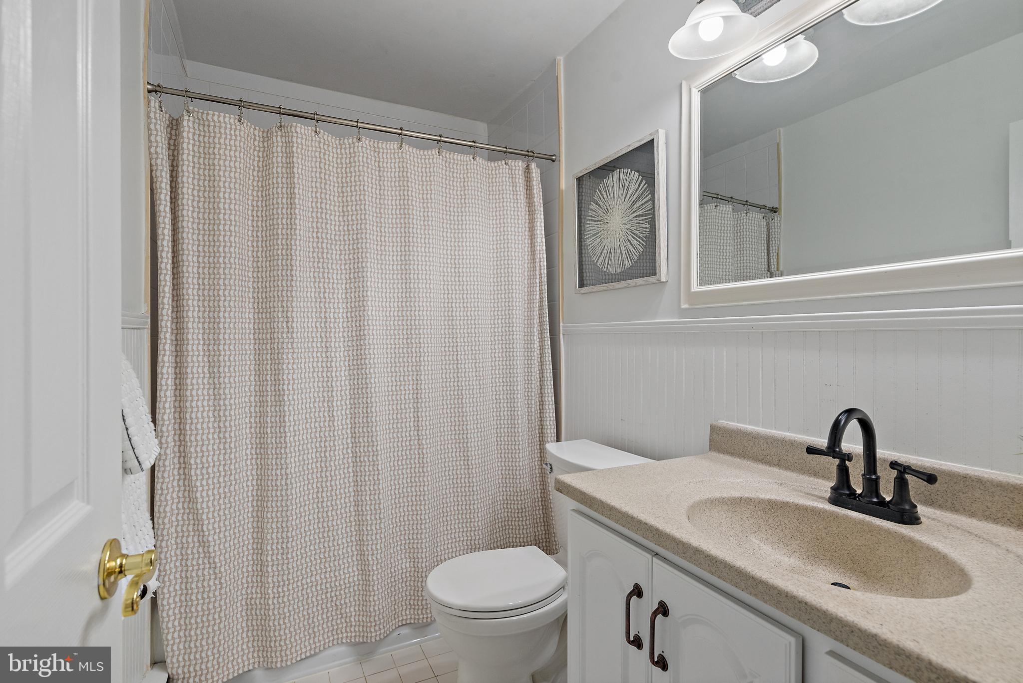 3514 Williamsburg Road Davidsonville, MD 21035 - Photo 28 of 50 a bathroom with a sink a toilet and a mirror
