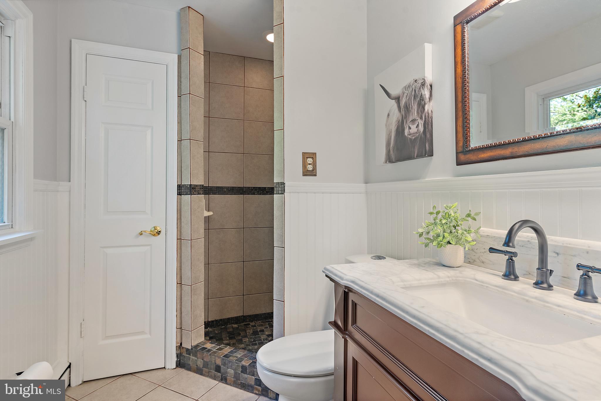 3514 Williamsburg Road Davidsonville, MD 21035 - Photo 29 of 50 a bathroom with a granite countertop sink toilet a mirror and shower