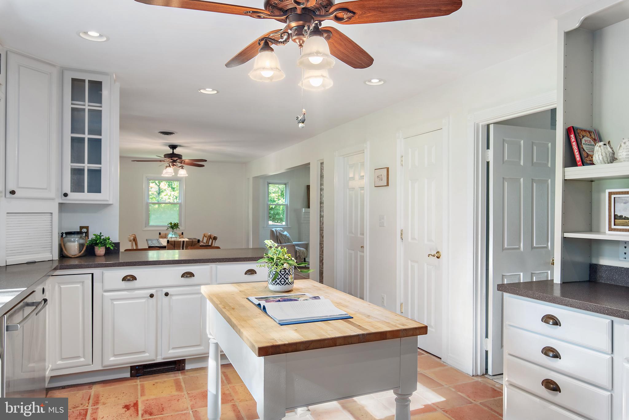 3514 Williamsburg Road Davidsonville, MD 21035 - Photo 5 of 50 a kitchen with white cabinets and chandelier