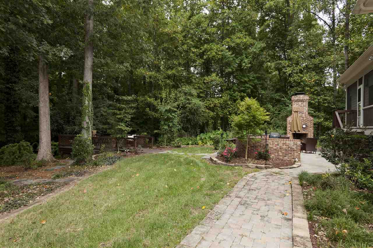 1700 Struble Circle Willow Spring, NC 27592 - Photo 24 of 25 Awesome back yard, features a plumbed outdoor kitchen, patio, flag stone walkway to deck, large wooded lot, just shy of two acres of beautifully landscaped land. Private Back Yard