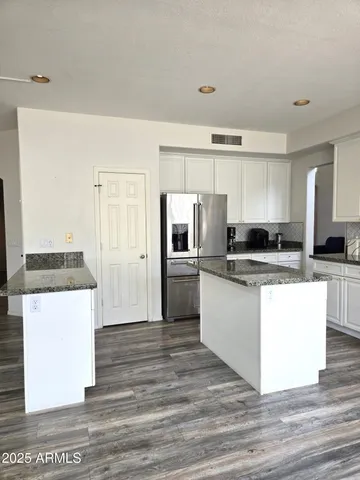a kitchen with cabinets a sink and white appliances