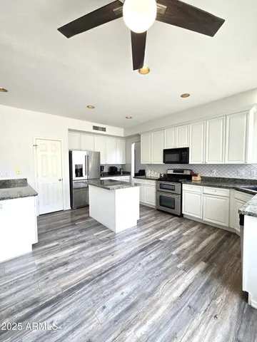 a spacious bathroom with a double vanity sink and mirror
