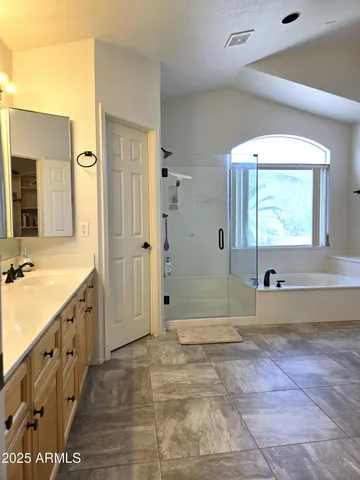a spacious bathroom with a tub and shower