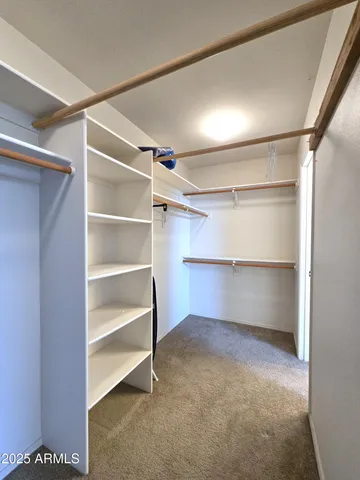 an empty room with windows and ceiling fan