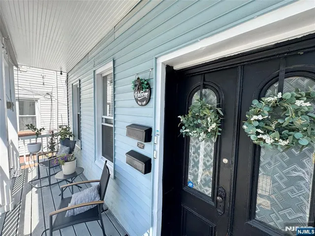 a front view of two chairs and potted plant