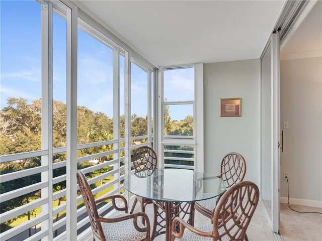 a table and chairs in a room next to a window