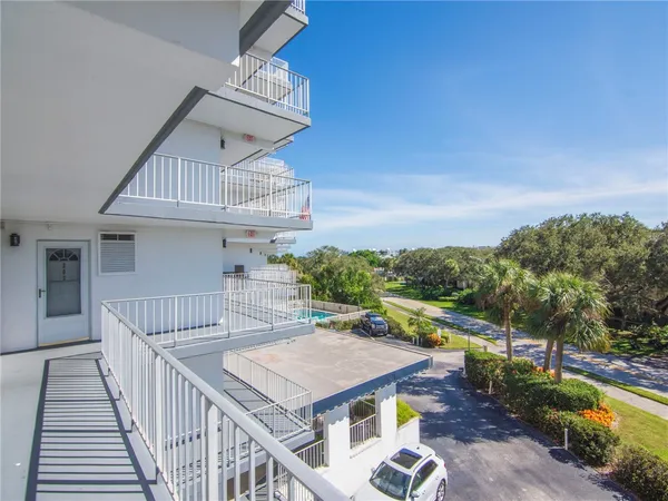 a view of a balcony with wooden floor