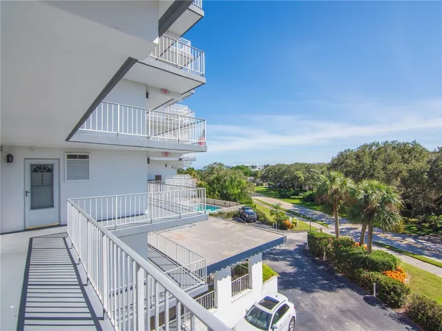 a view of a balcony with wooden floor