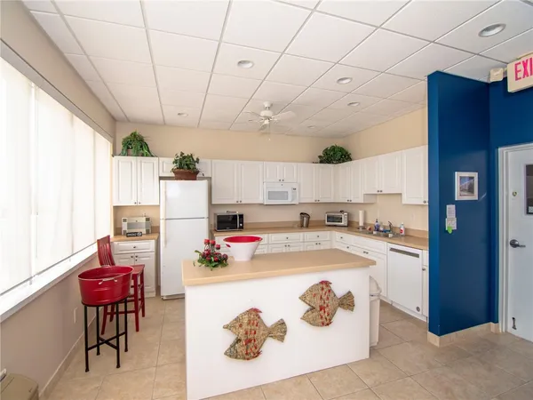 a kitchen with a stove a refrigerator and a dining table