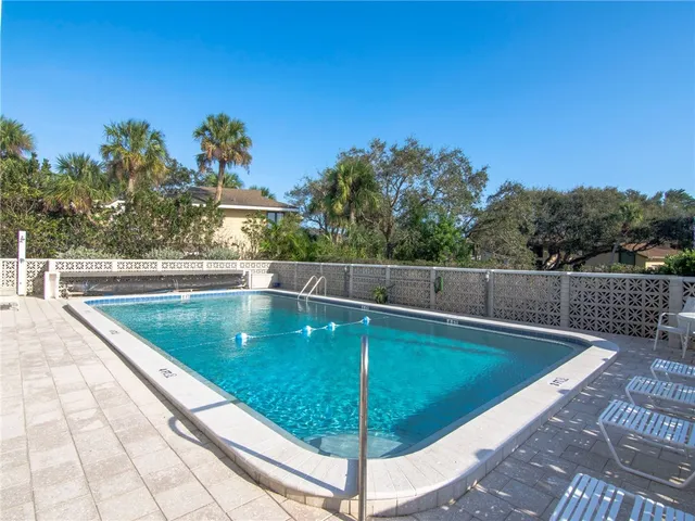 a view of a swimming pool with a lounge chair