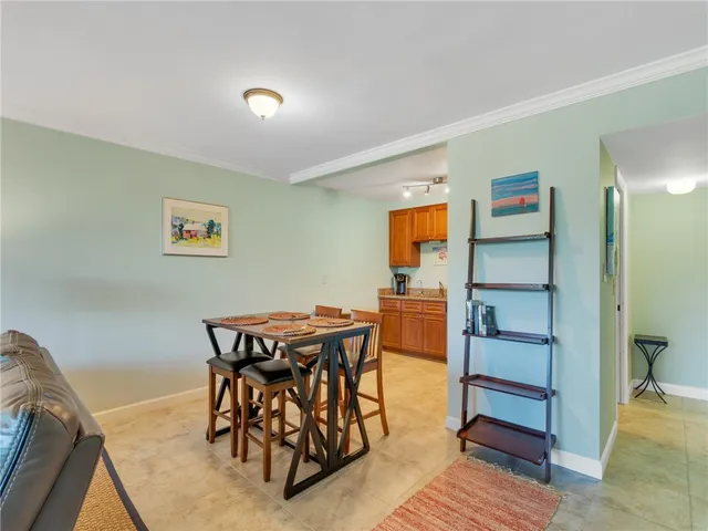 a view of a dining room with furniture and a chandelier