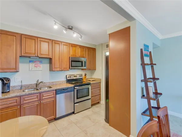 a kitchen with stainless steel appliances granite countertop a refrigerator and a stove top oven