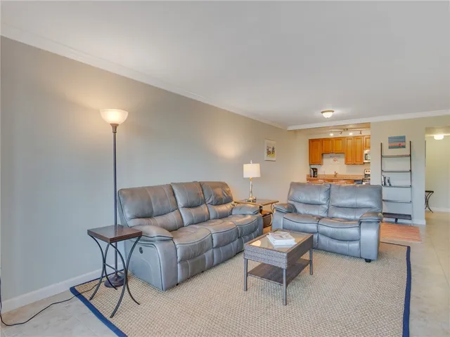 a living room with furniture and a lamp