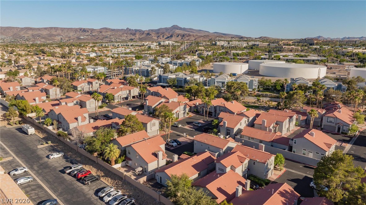 2254 Ramsgate Drive Henderson, NV 89074 - Photo 40 of 43 An aerial perspective reveals a vibrant community with terracotta rooftops against a desert mountain backdrop.