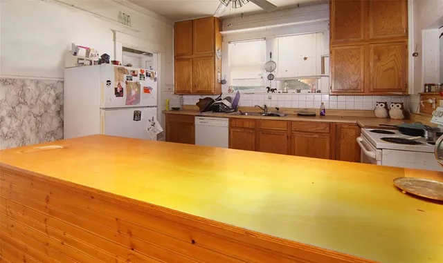 a kitchen with a sink stove and refrigerator