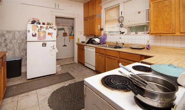 a kitchen with a sink stove and refrigerator