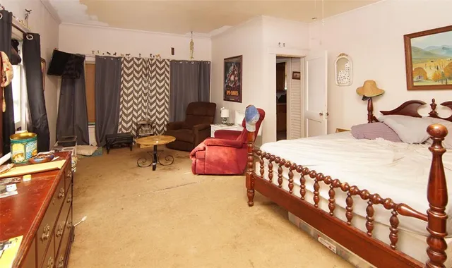 a bedroom with furniture and a flat screen tv