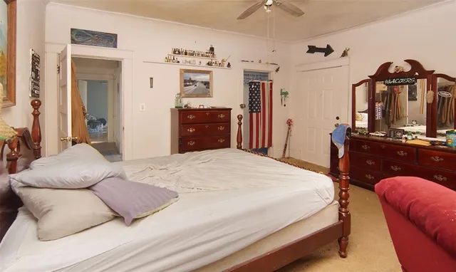 a bedroom with bed and cabinets
