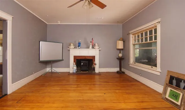 a view of an empty room with a fireplace and a window