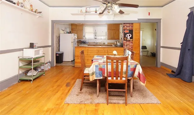 a living room with dining room and wooden floor
