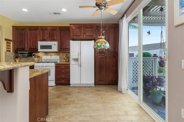 a kitchen with stainless steel appliances a refrigerator and a stove top oven