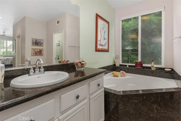 a bathroom with a sink double vanity and a granite