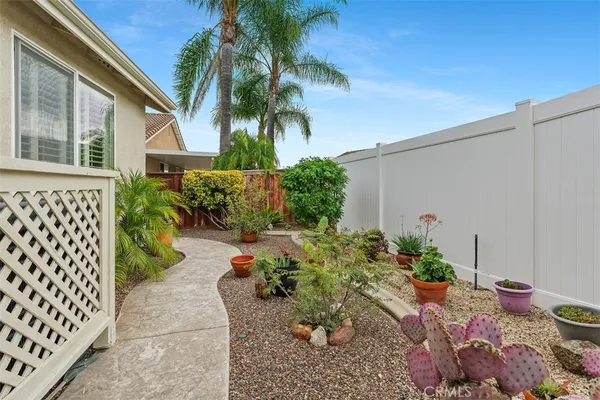 a couple of flower plants in front of house