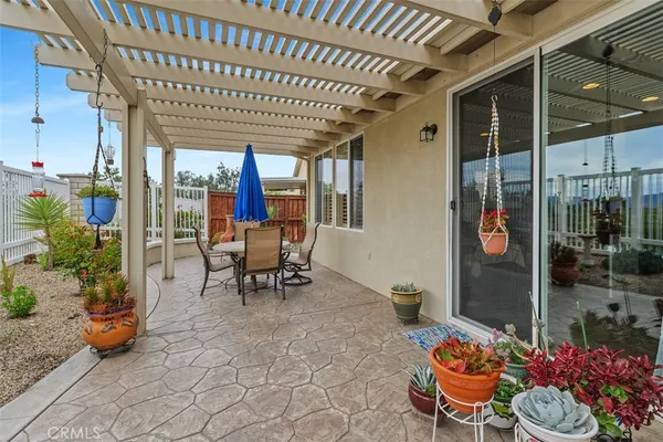 a patio with yard glass top table and chairs